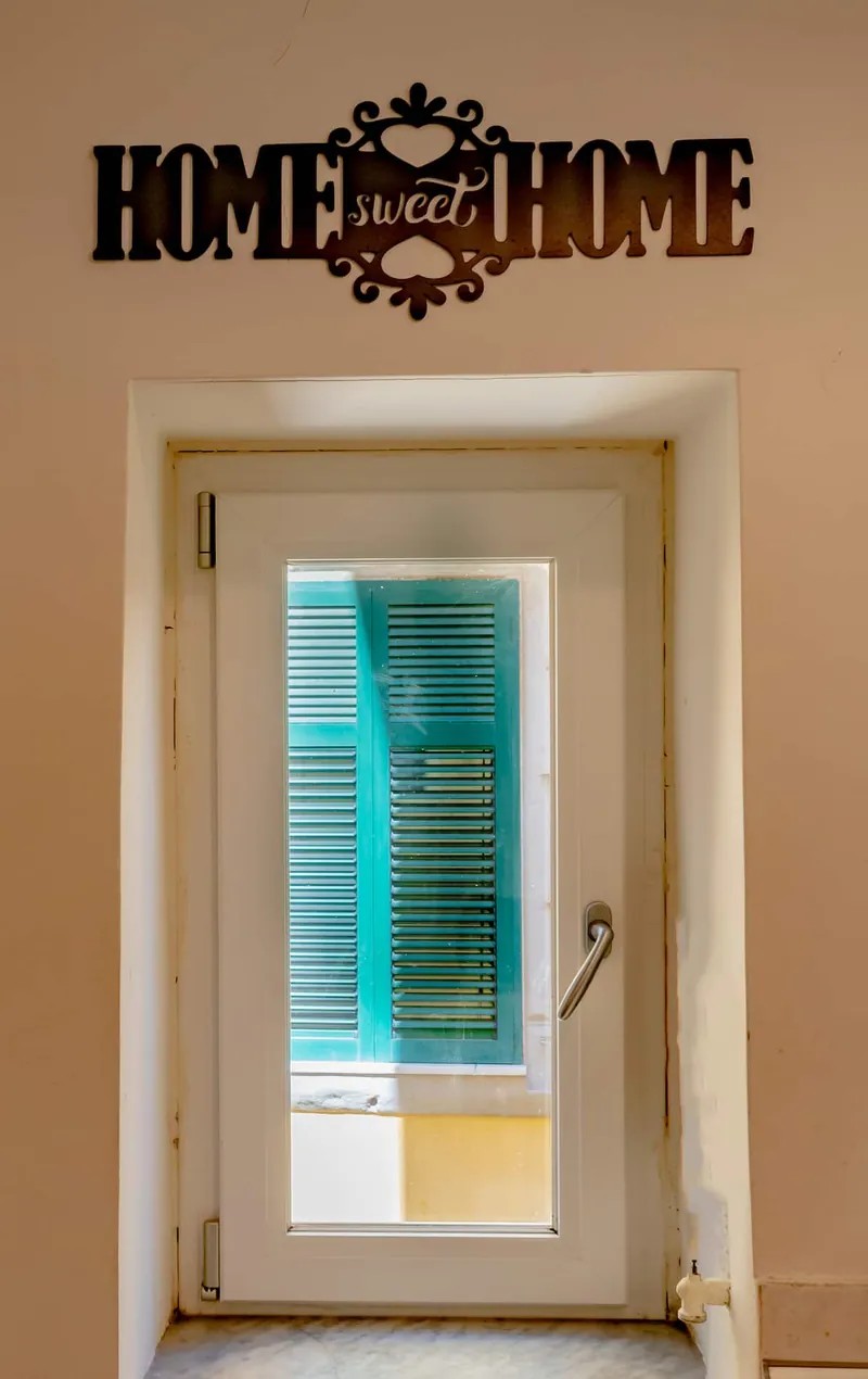 The “Home sweet home” sign above the bathroom door.